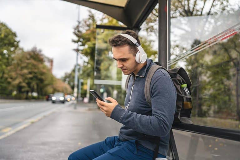 Een student wacht op de bus