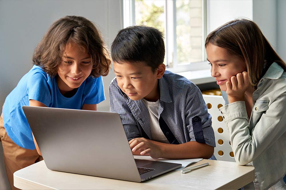 Drie kinderen achter een laptop